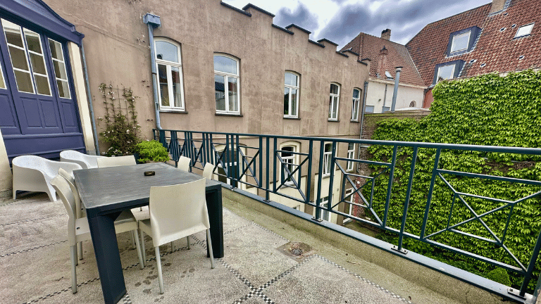 Spacious private terrace of an apartment in the city center of Bruges with furniture.